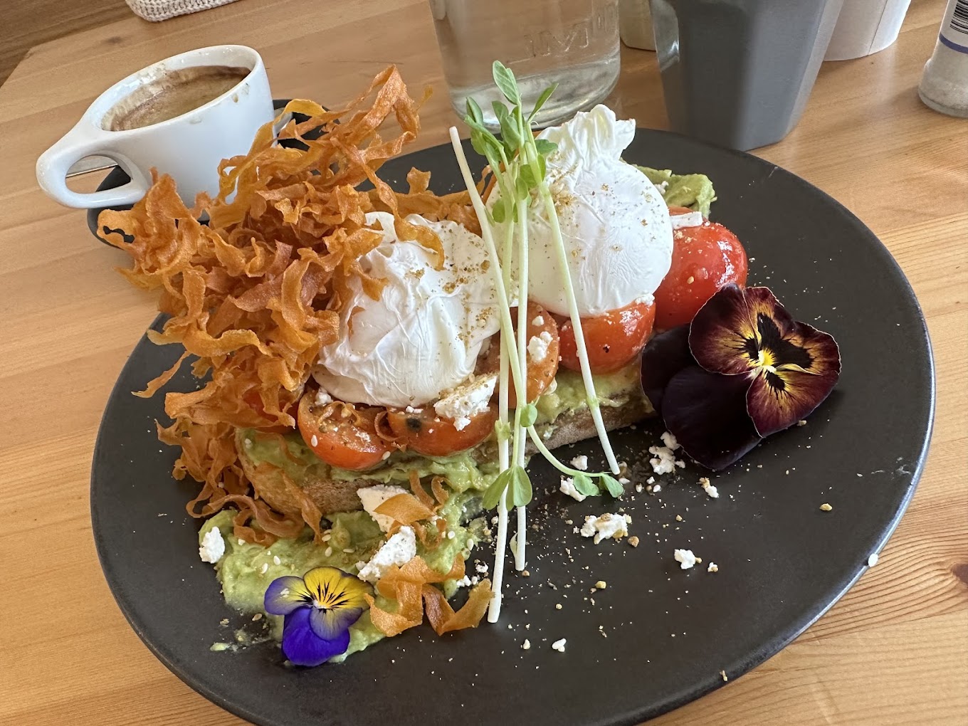 Poached eggs with avocado and crispy potatoes at The Foliage Cafe North Sydney