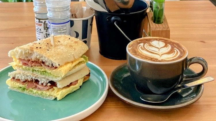 Toasted sandwich with latte art coffee at The Foliage Cafe